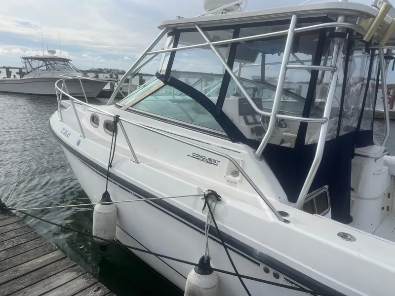 Slide: The Image of 2002 Boston Whaler 295 Conquest WA docked at marina. - 26