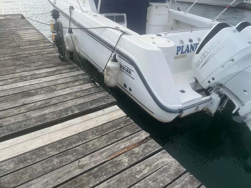 Slide: The Image of 2002 Boston Whaler 295 Conquest WA docked with Suzuki outboard engines. - 29