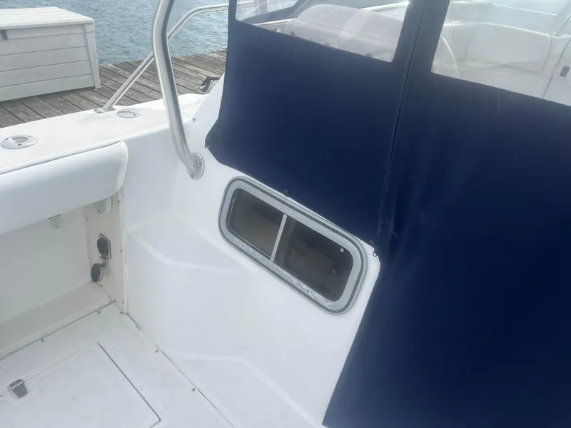 Slide: The Image of Boston Whaler 295 Conquest WA 2002 boat interior with blue canvas and window. - 35