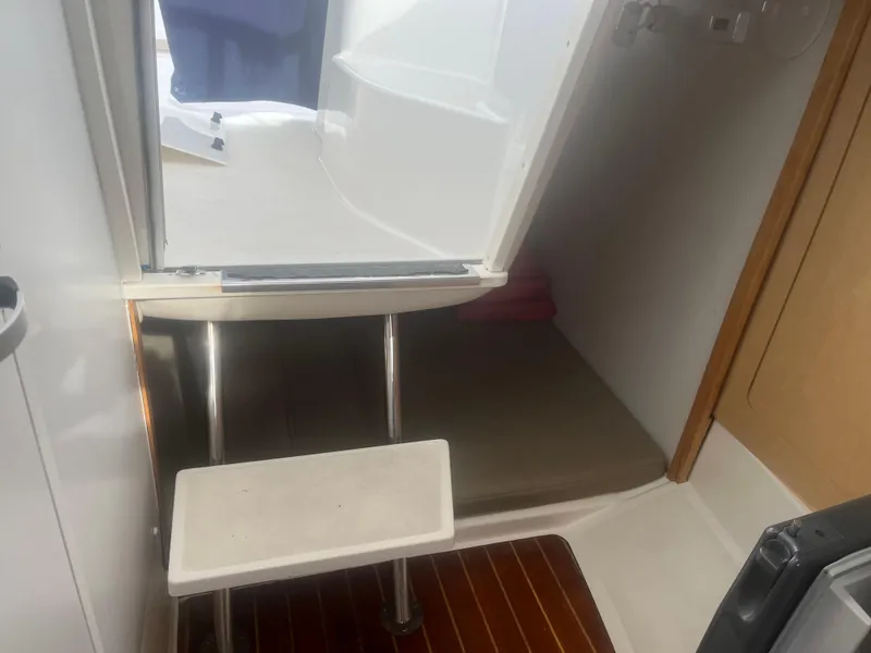 Slide: The Image of Interior cabin of 2002 Boston Whaler 295 Conquest WA with steps and seating area. - 43