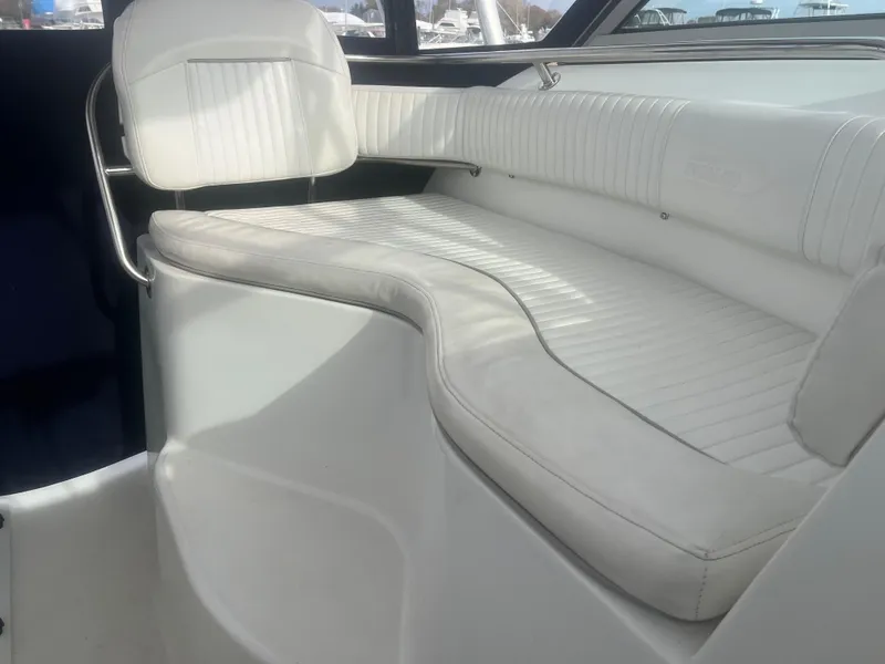 Slide: The Image of Interior seating of 2002 Boston Whaler 295 Conquest WA boat, featuring white cushioned seats. - 46