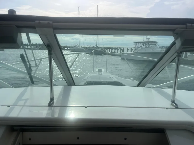 Slide: The Image of Boston Whaler 295 Conquest WA 2002, docked with marina view through windshield. - 47