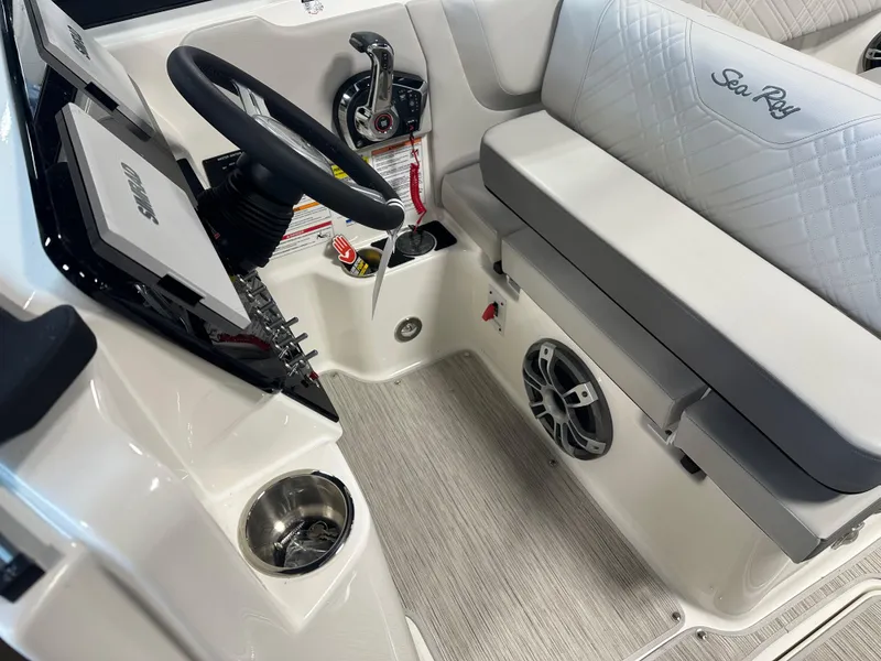Slide: The Image of 2025 Sea Ray SDX 250 boat interior with steering wheel and seating area. - 16