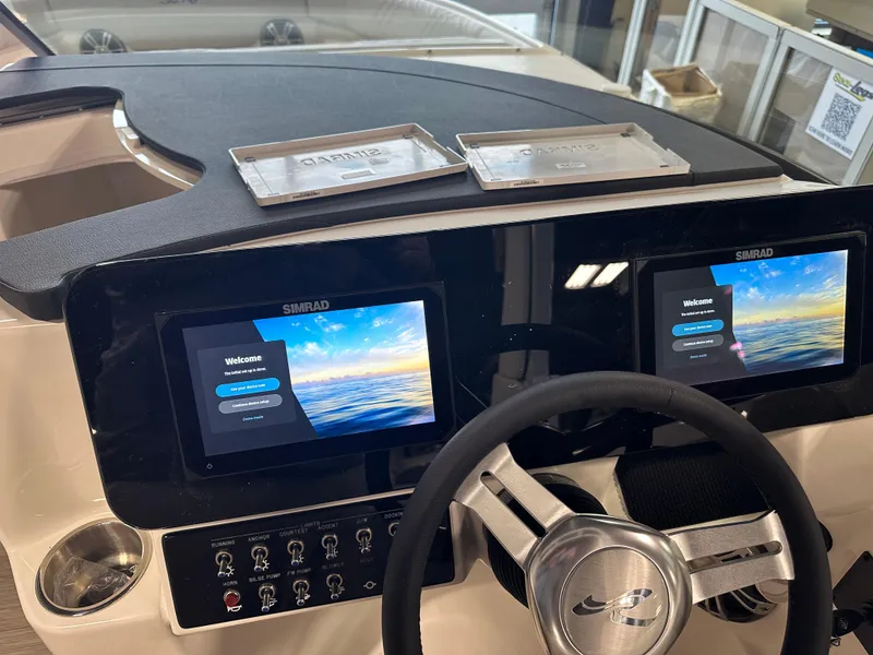 Slide: The Image of 2025 Sea Ray SDX 250 dashboard with dual Simrad displays and steering wheel. - 18