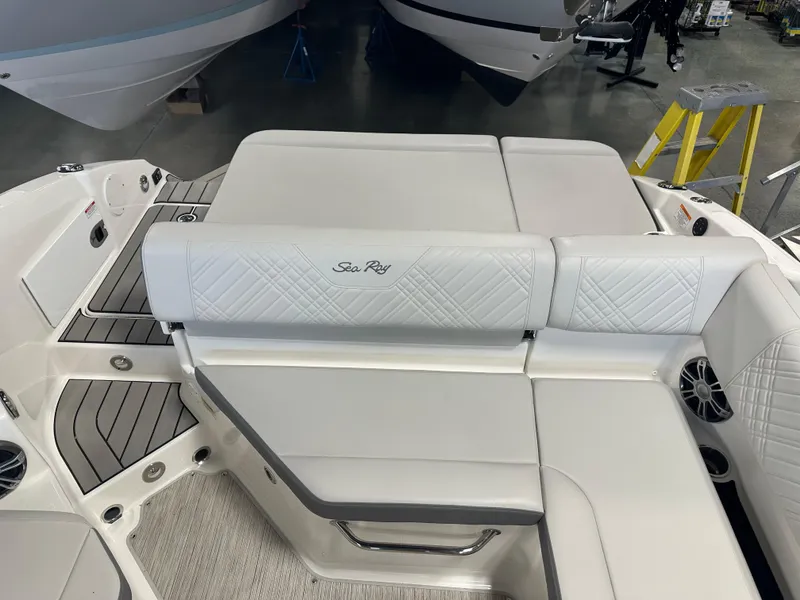 Slide: The Image of 2025 Sea Ray SDX 250 boat interior with white cushioned seating and sleek design. - 19