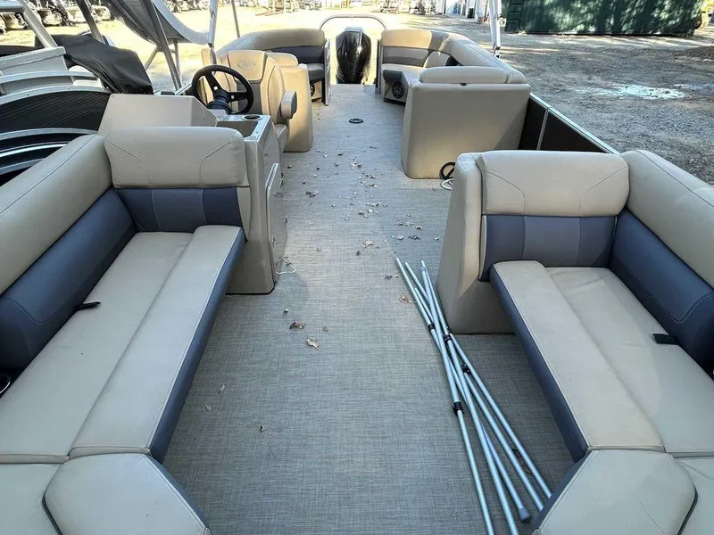 Slide: The Image of 2021 Harris Cruiser 250 pontoon boat interior with beige seating and steering console. - 14