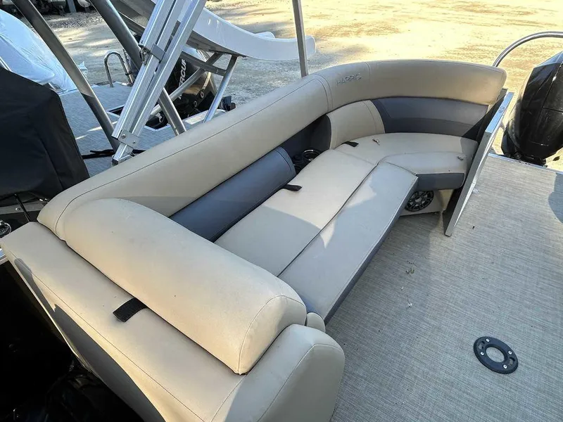 Slide: The Image of 2021 Harris Cruiser 250 boat interior with beige seating and spacious layout. - 5