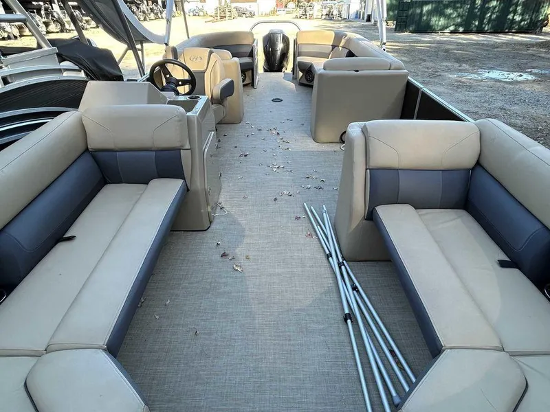 Slide: The Image of 2021 Harris Cruiser 250 pontoon boat interior with beige seating and steering console. - 6