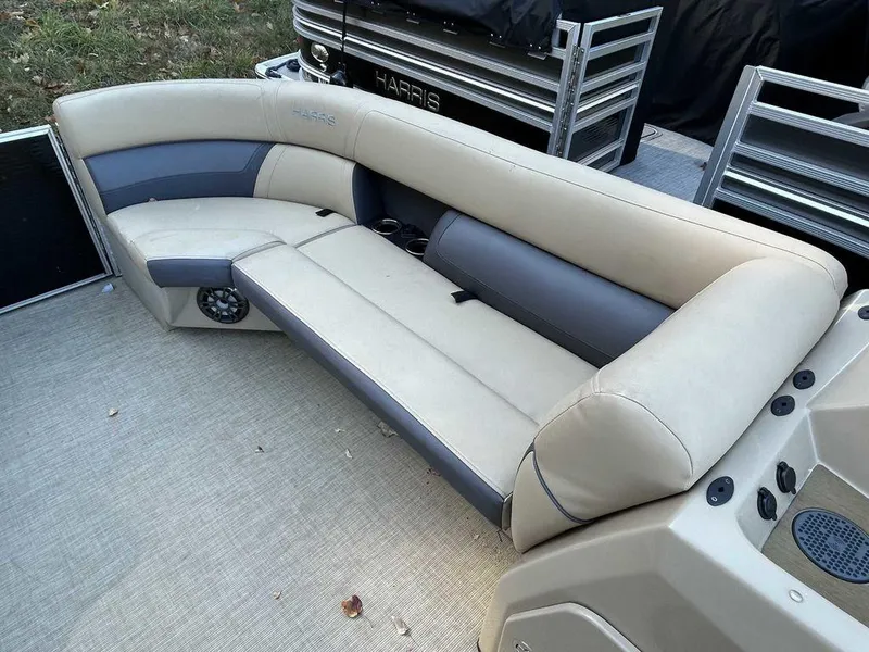 Slide: The Image of 2021 Harris Cruiser 250 boat interior with beige and gray seating. - 7