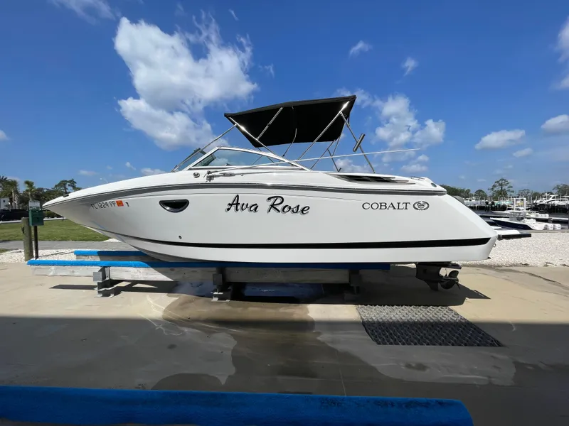 The Image of 2013 Cobalt 24SD boat on lift under blue sky with clouds. - 0