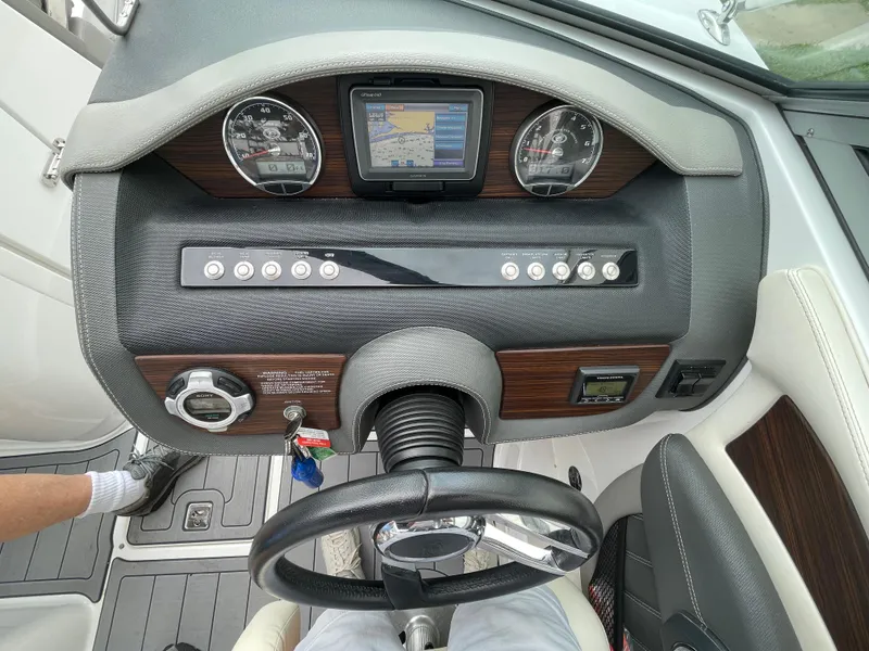 Slide: The Image of Dashboard of a 2013 Cobalt 24SD boat with steering wheel and navigation system. - 14