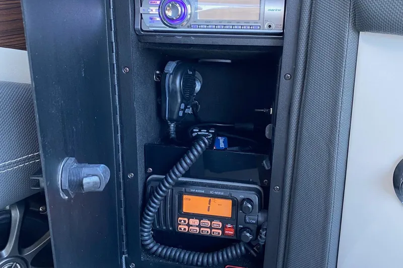 Slide: The Image of 2013 Cobalt 24SD boat radio and communication equipment in storage compartment. - 18