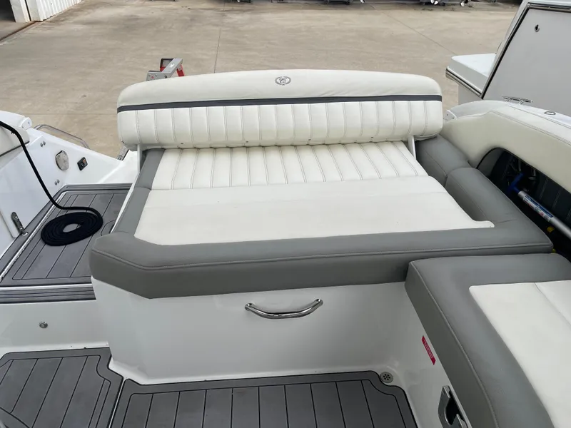 Slide: The Image of 2013 Cobalt 24SD boat interior with white and gray seating. - 27