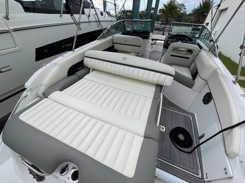 Slide: The Image of 2013 Cobalt 24SD boat interior with white and gray seating, sleek design. - 28