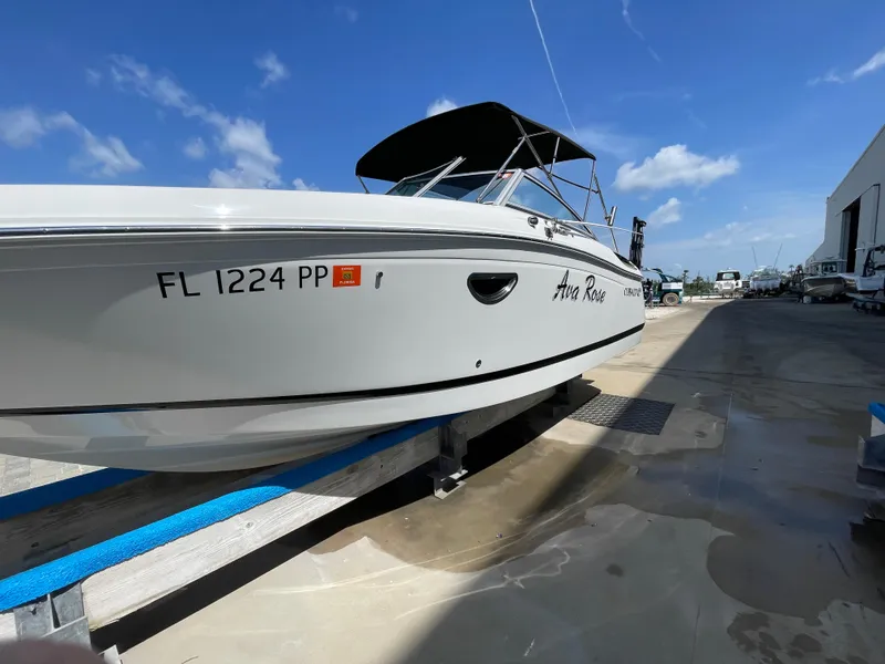 Slide: The Image of 2013 Cobalt 24SD boat on trailer under clear blue sky. - 3