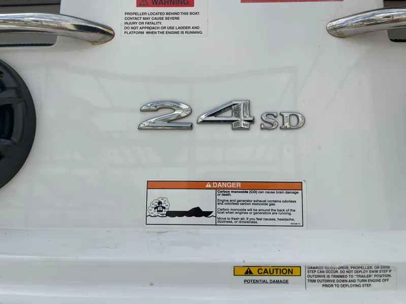 Slide: The Image of 2013 Cobalt 24SD boat emblem with safety warnings and caution labels. - 35
