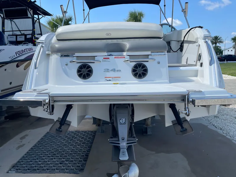 Slide: The Image of Rear view of a 2013 Cobalt 24SD boat with dual speakers and outboard motor. - 37
