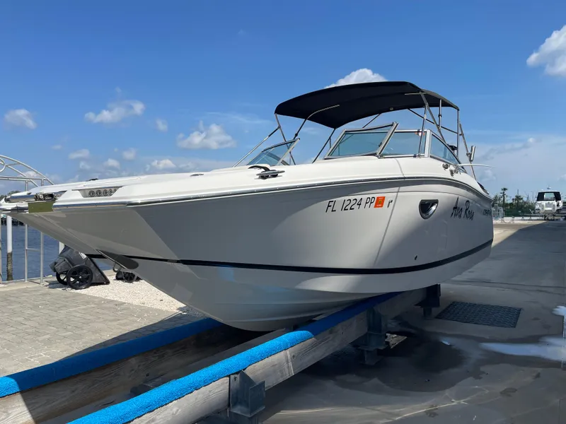 Slide: The Image of 2013 Cobalt 24SD boat on dock under clear blue sky. - 4