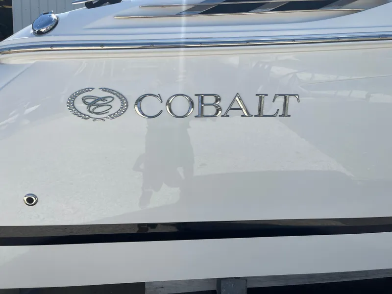 Slide: The Image of 2013 Cobalt 24SD boat with logo on white hull. - 5