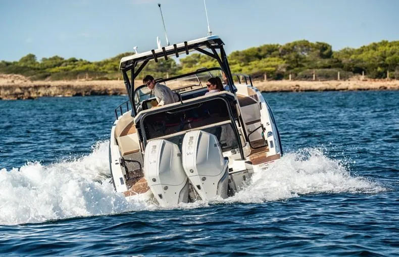 Slide: The Image of Navan S30 2025 motorboat cruising on open water, rear view. - 10