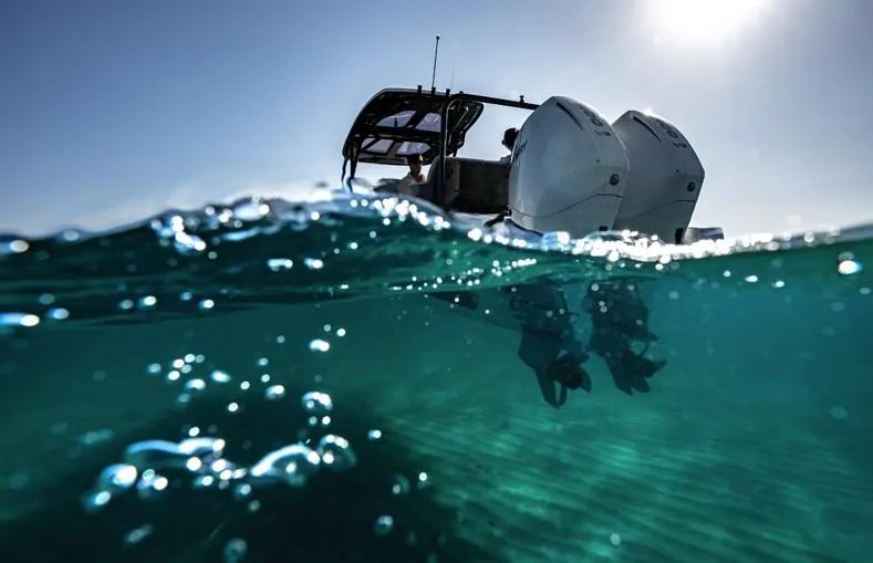 Slide: The Image of Navan S30 boat engines partially submerged in clear blue water, 2025 model. - 11