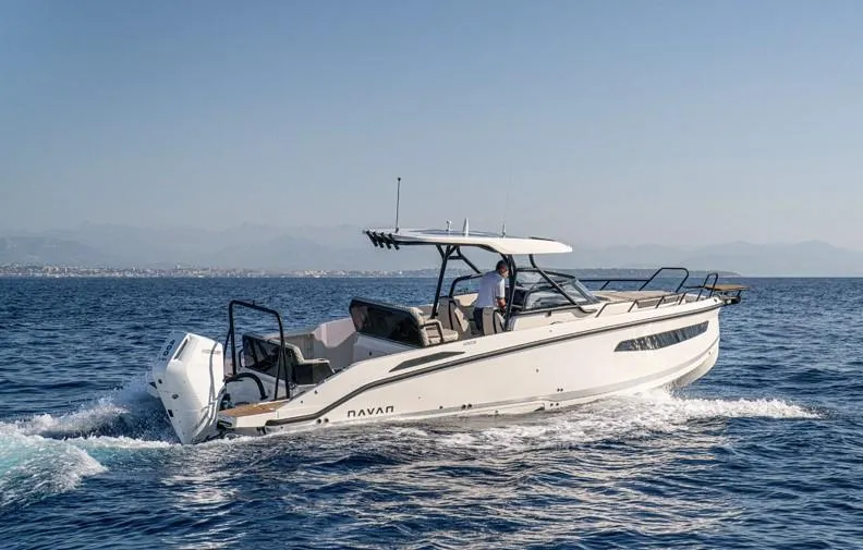 Slide: The Image of Navan S30 2025 boat cruising on open water under clear skies. - 4