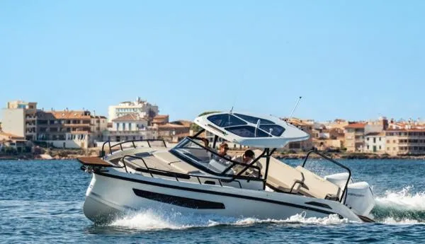 Slide: The Image of Navan S30 2025 boat cruising near coastal town, clear blue sky. - 9