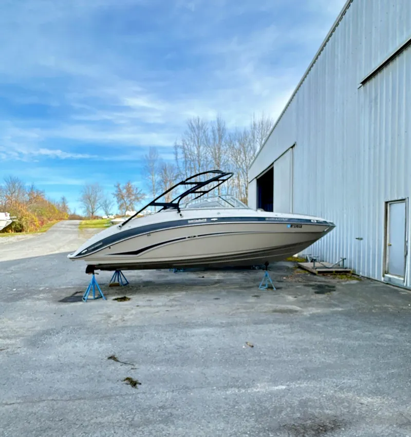 Slide: The Image of 2012 Yamaha Boats 242 Limited S on stands outside a large warehouse. - 0