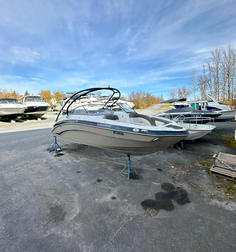 Slide: The Image of 2012 Yamaha Boats 242 Limited S on stands in a boatyard under a clear sky. - 1