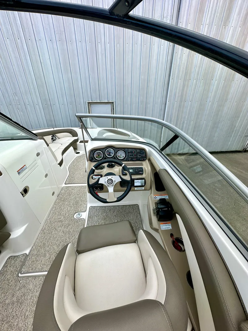 Slide: The Image of 2012 Yamaha Boats 242 Limited S cockpit with steering wheel and dashboard controls. - 10
