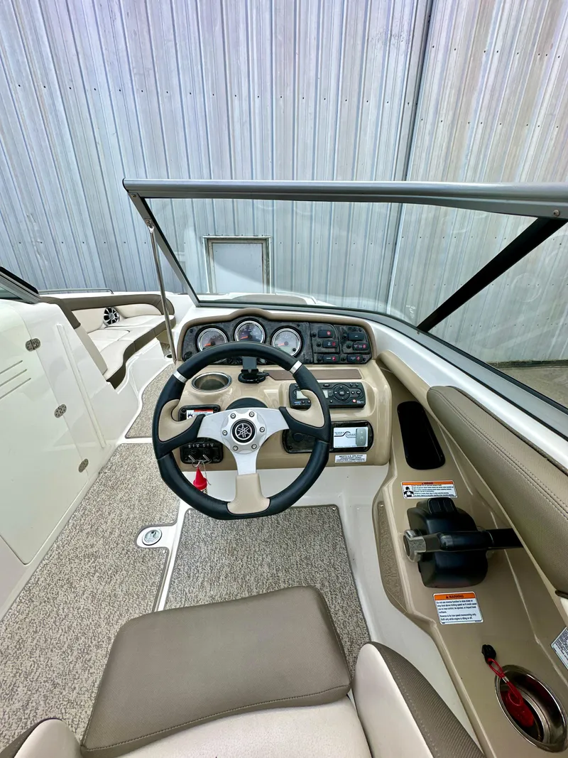 Slide: The Image of 2012 Yamaha Boats 242 Limited S cockpit with steering wheel and control panel. - 11