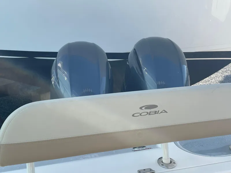 Slide: The Image of 2018 Cobia 261 boat with dual engines and branded seating. - 10