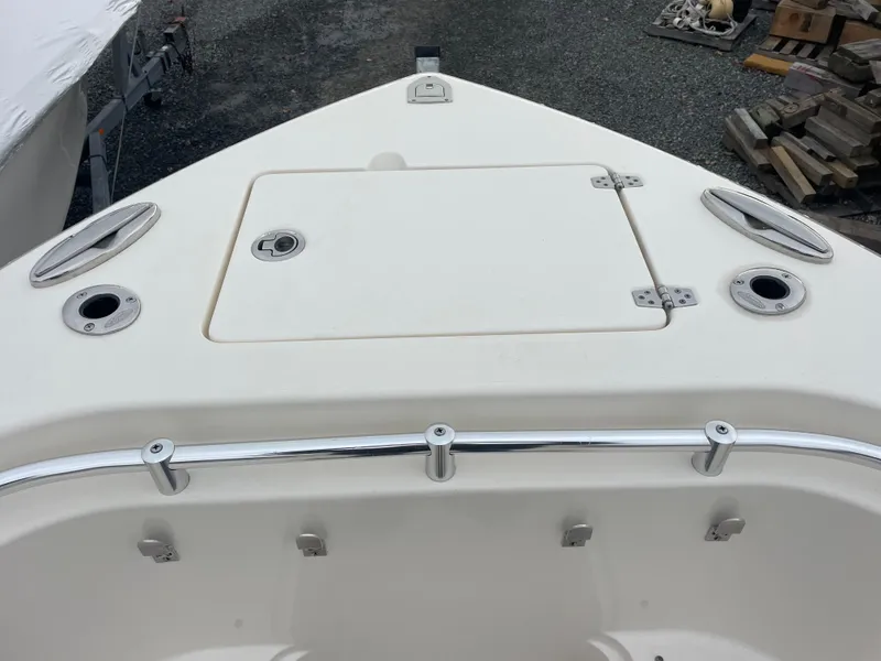 Slide: The Image of 2018 Cobia 261 boat bow with storage hatch and stainless steel fittings. - 14