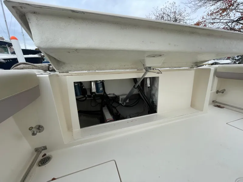 Slide: The Image of Open storage compartment on 2018 Cobia 261 boat deck. - 15