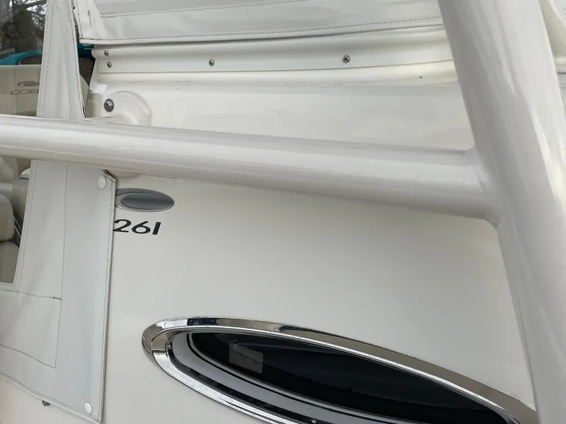 Slide: The Image of 2018 Cobia 261 boat detail with railing and window. - 18