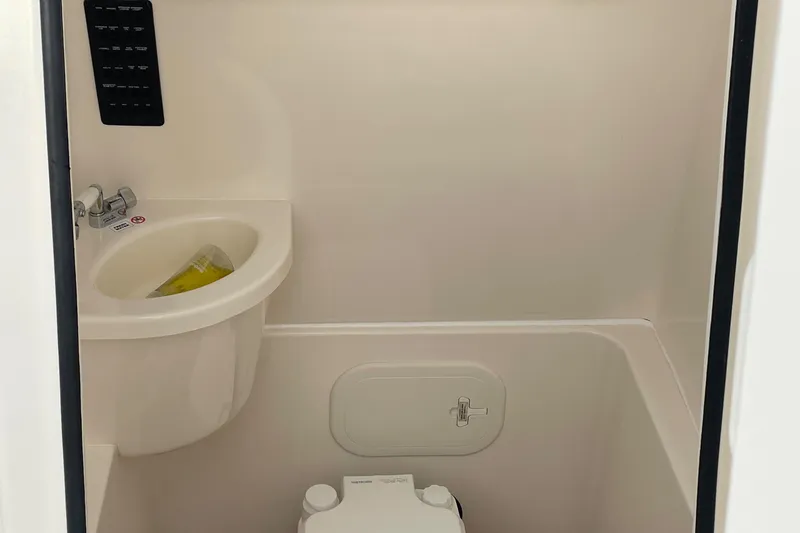 Slide: The Image of 2018 Cobia 261 boat bathroom with sink and toilet. - 20