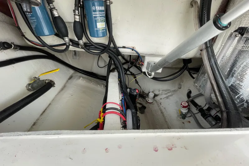 Slide: The Image of 2018 Cobia 261 boat engine compartment with Yamaha filters and wiring. - 24