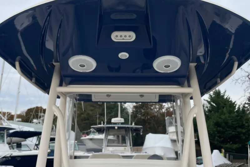 Slide: The Image of 2018 Cobia 261 boat with blue T-top and white supports. - 6