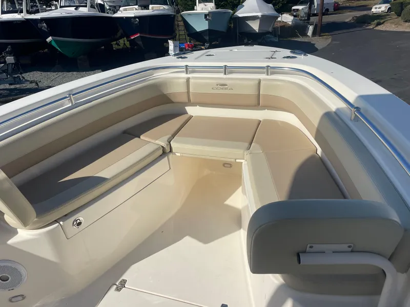 Slide: The Image of 2018 Cobia 261 boat interior with beige seating and spacious deck. - 8