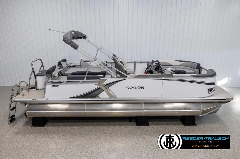 Slide: The Image of 2025 Avalon LSZ QLS pontoon boat in showroom, side view. - 1