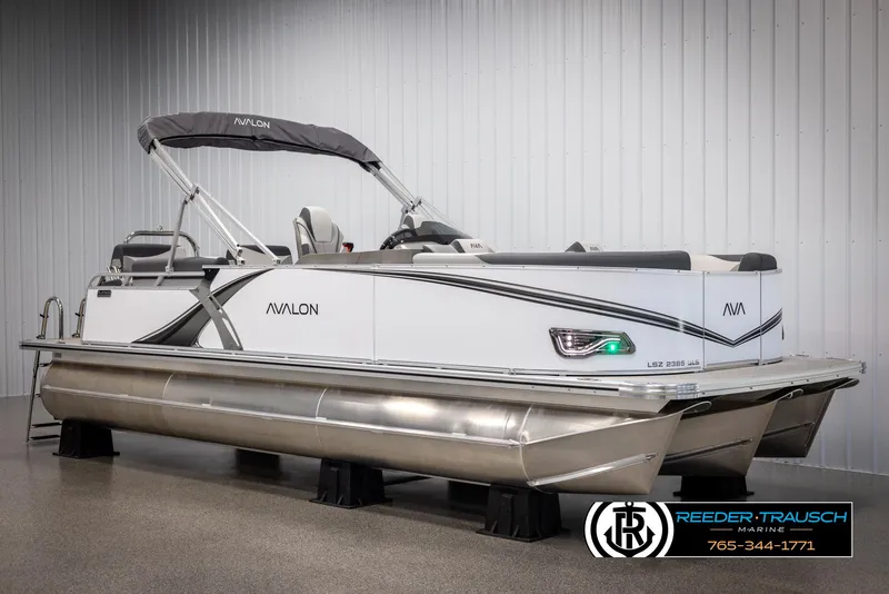 Slide: The Image of 2025 Avalon LSZ QLS pontoon boat in showroom, sleek design, modern features. - 2