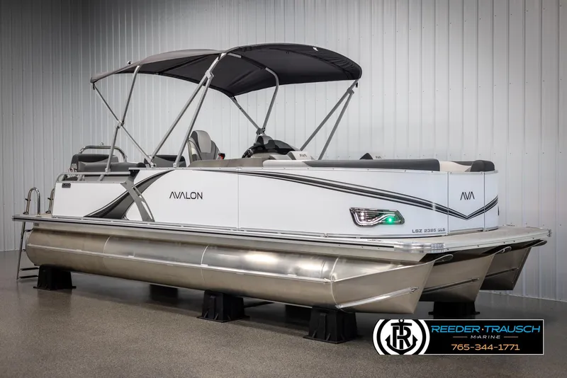 Slide: The Image of 2025 Avalon LSZ QLS pontoon boat with canopy in showroom. - 3