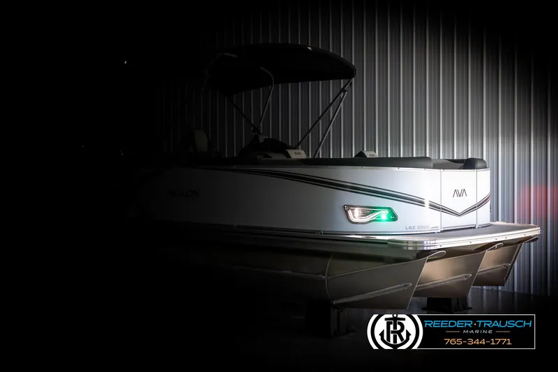 Slide: The Image of 2025 Avalon LSZ QLS pontoon boat in dimly lit showroom. - 4