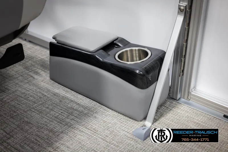 Slide: The Image of 2025 Avalon LSZ QLS boat interior with cup holder and armrest on carpeted floor. - 41