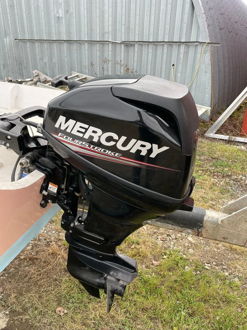 Slide: The Image of Mercury FourStroke outboard motor on 2017 Rossiter Estate Skiff, parked outdoors. - 6
