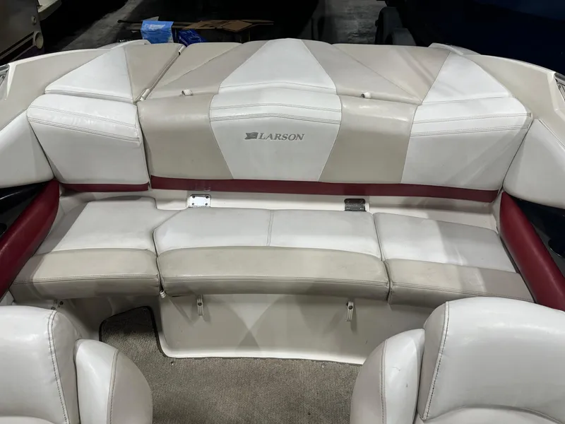 Slide: The Image of 2007 Larson LXi 208 boat interior with white and red seating. - 10