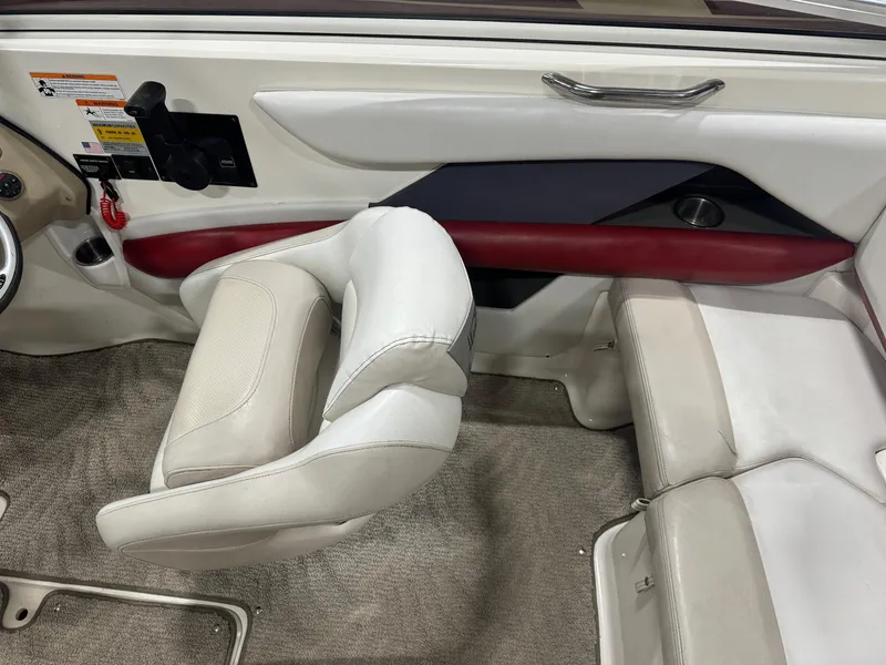 Slide: The Image of 2007 Larson LXi 208 boat interior with white and red seating. - 11