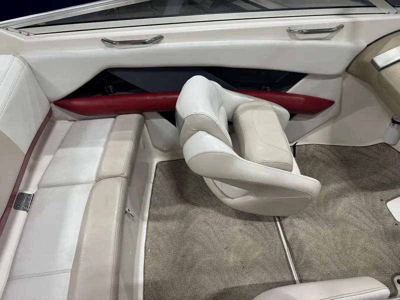 Slide: The Image of 2007 Larson LXi 208 boat interior with white and red seating. - 12
