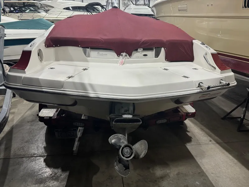 Slide: The Image of 2007 Larson LXi 208 boat with maroon cover in storage. - 4