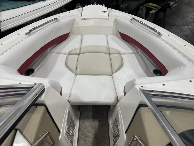 Slide: The Image of 2007 Larson LXi 208 boat interior with white and red seating. - 5